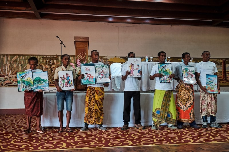 People holding paintings. Photo courtesy of Madagascar PHE Network