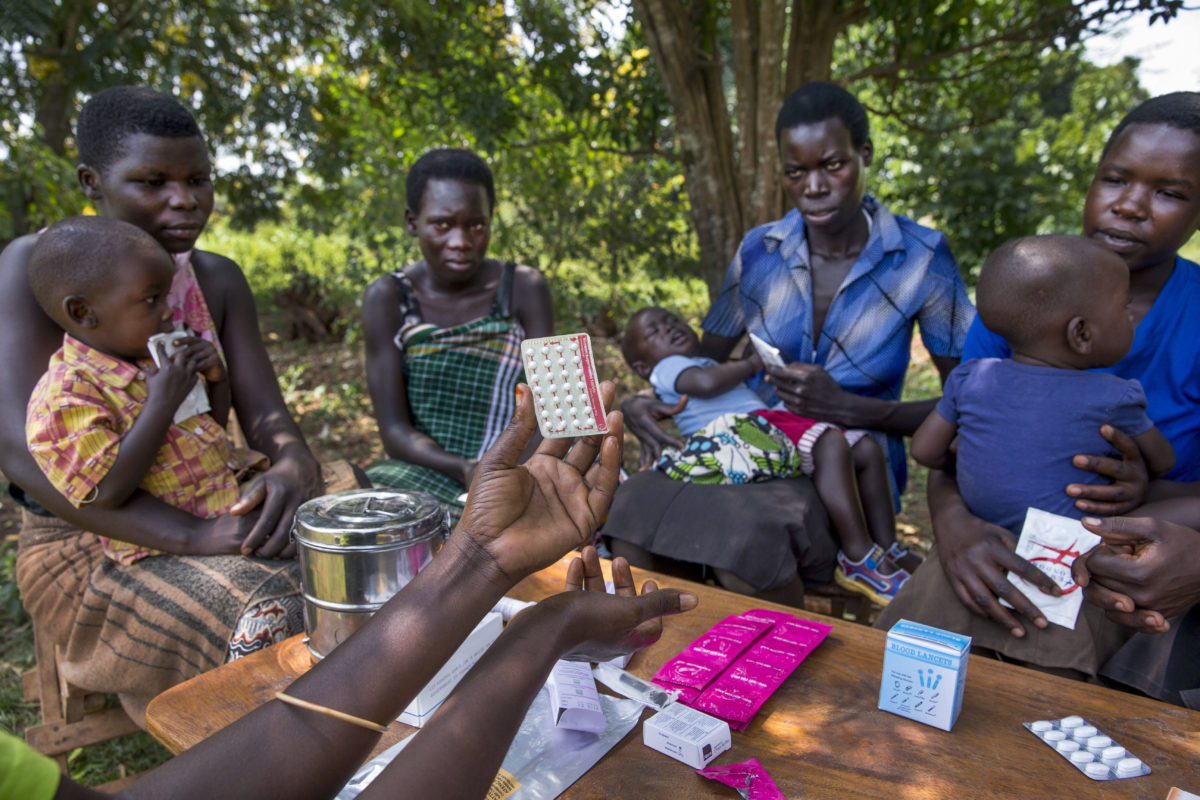 Women from the Young Mothers Group meeting and getting family planning information from a community health worker. The program is supported by Reproductive Health Uganda, with the goal to empower the women in the group, and provide them with family planning information.